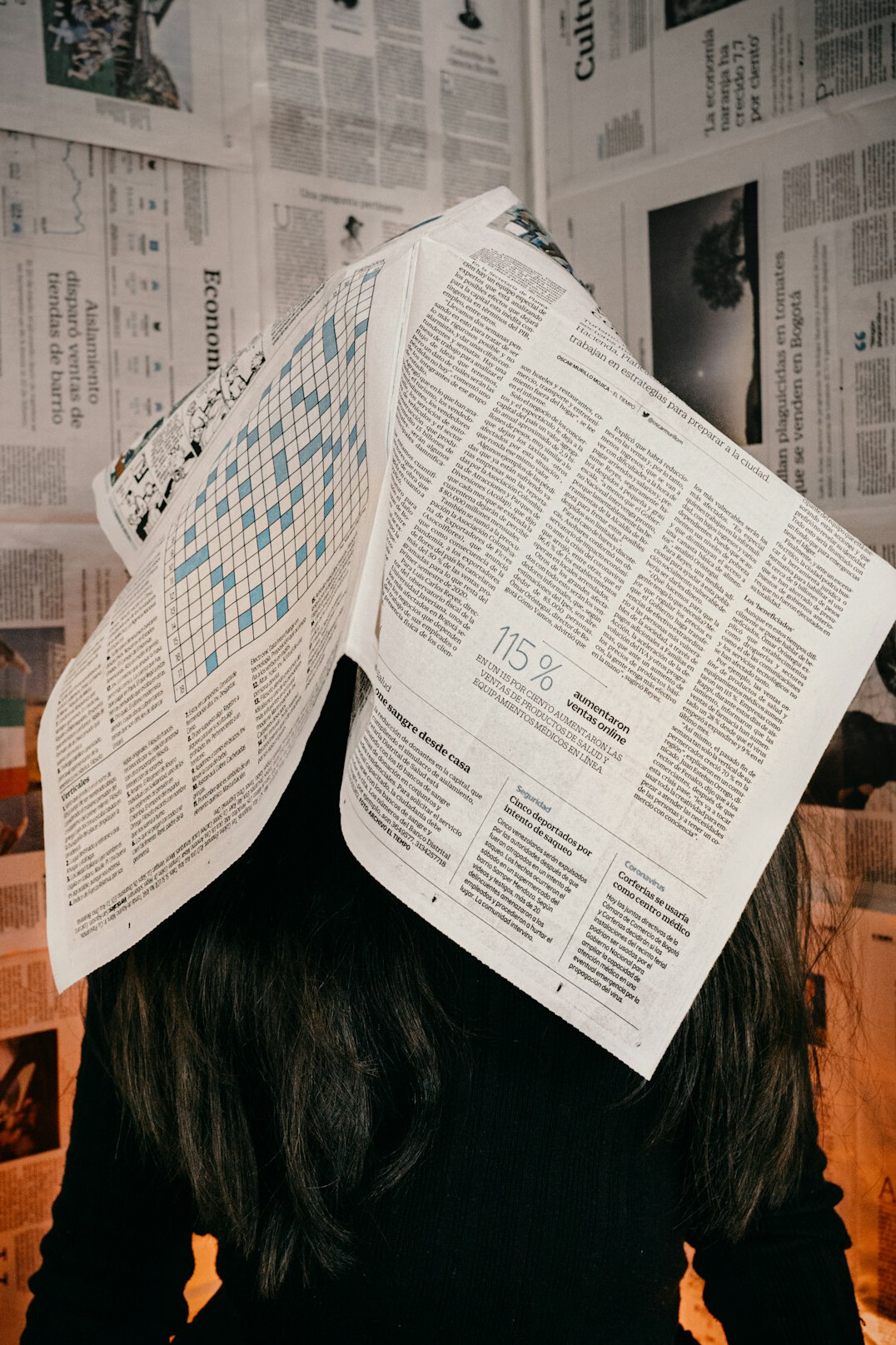 person reading old newspapers